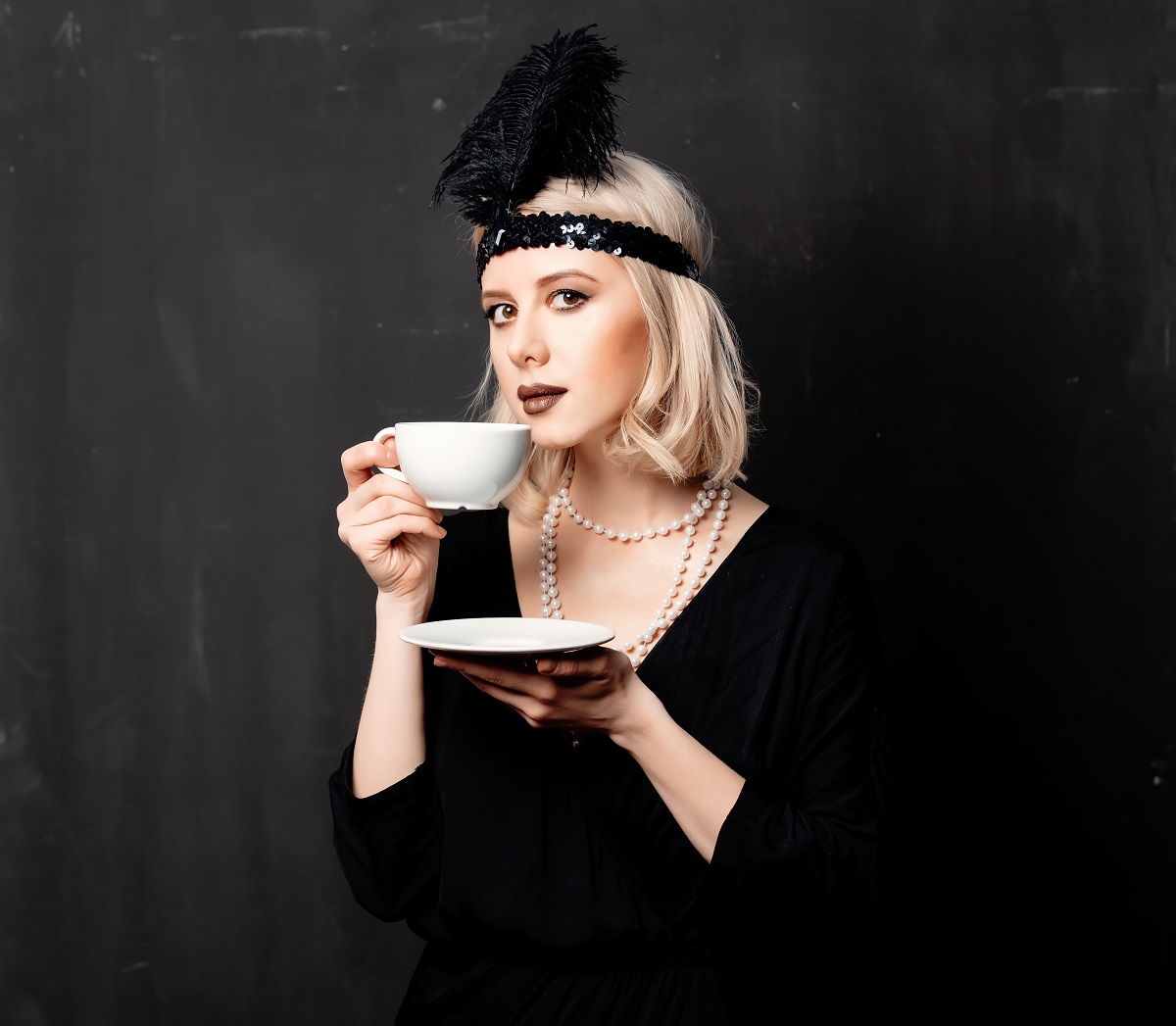 woman in twenties years clothes with cup of coffee