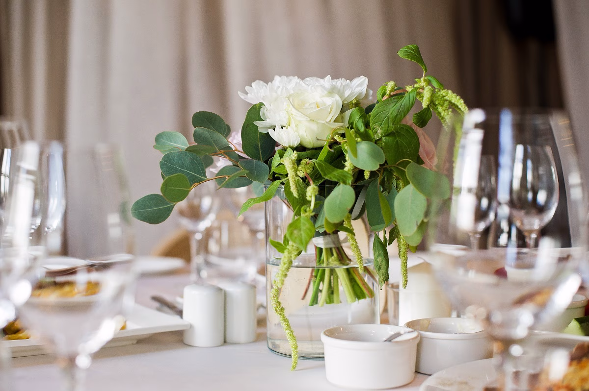 Wedding dinner in the restaurant, tables decorated with vases of