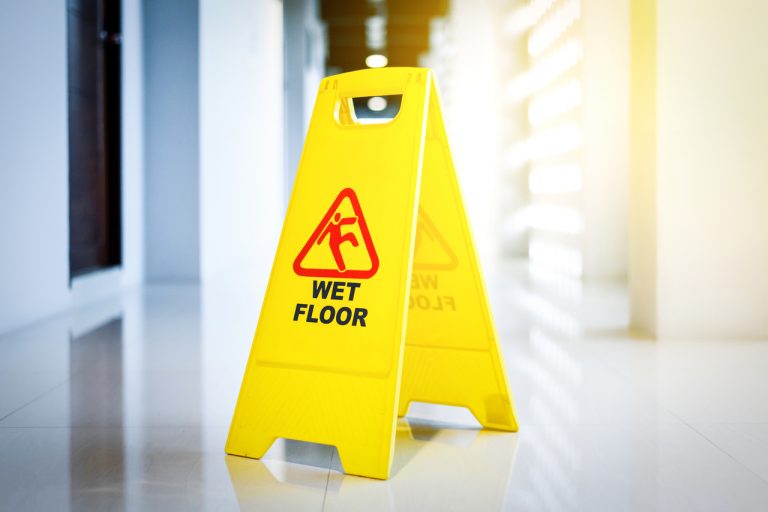 A Wet Floor sign in a hotel