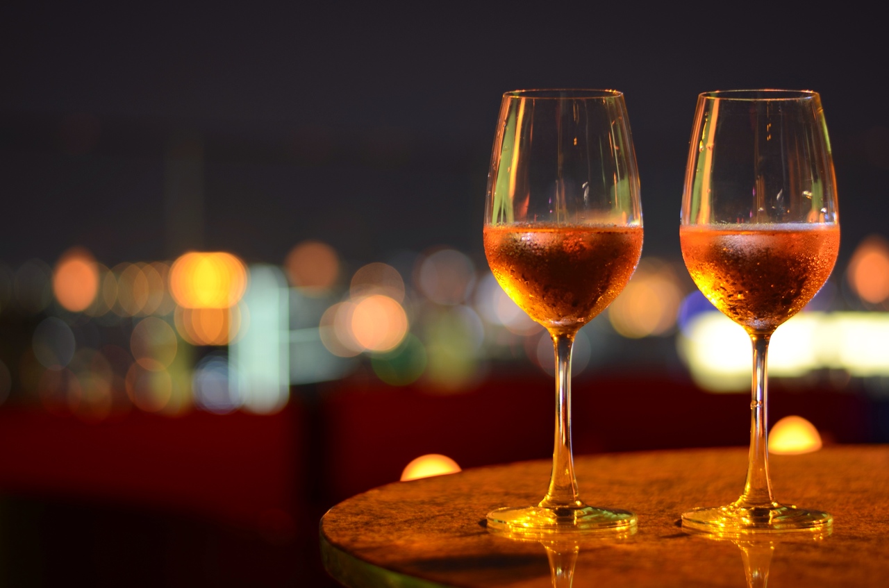 Two wine glasses on a rooftop restaurant