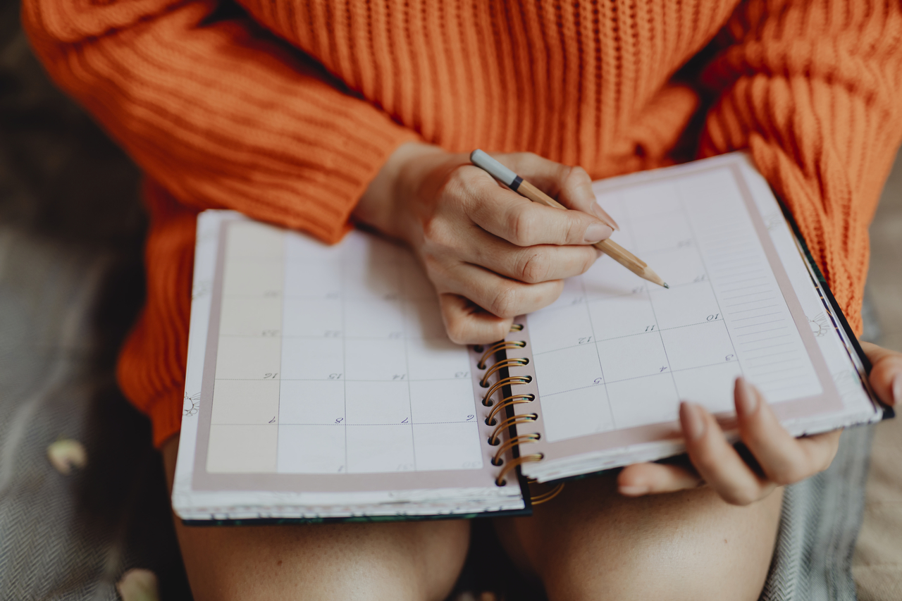 A woman planning an event on a calendar