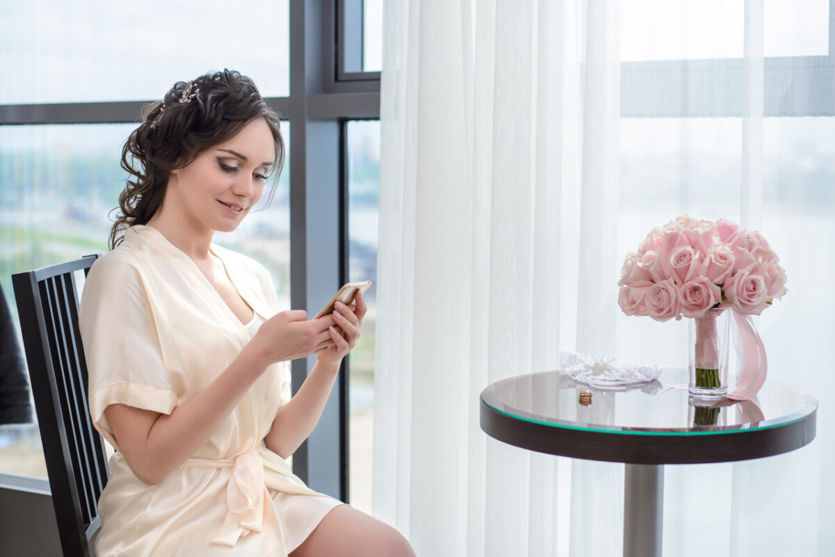 A bride on a video call with her bridesmaids